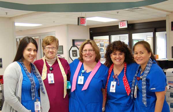 Parkridge ER staff show off a few of the neck wraps. L – R: Liz Lopez, RN; Susan Ruth, Unit Secretary/PCT; Malena Condon, RN; Dawn Sisson, RN; Consuelo Salud, RN