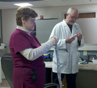 Parkridge ER Unit Secretary Susan Ruth and Dr. Kenneth Hayman work on a couple of neck wraps.